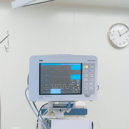 A modern heart rate monitor in a sterile hospital setting, showcasing medical technology.